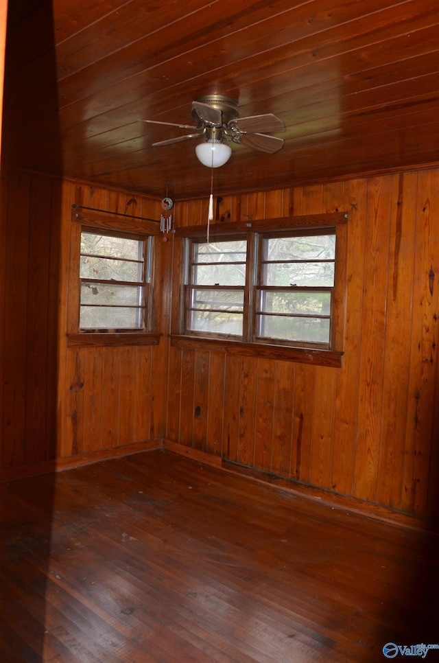 unfurnished room featuring a wealth of natural light, a ceiling fan, wood ceiling, and wood-type flooring