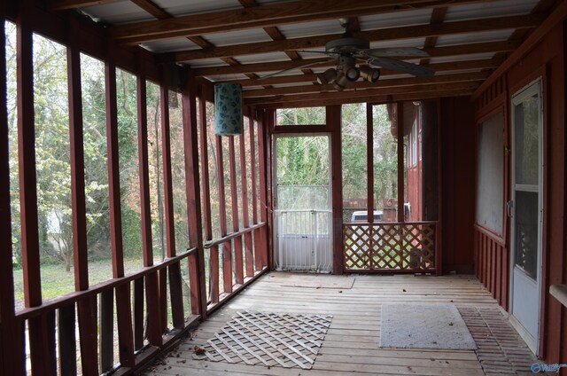 unfurnished sunroom with ceiling fan
