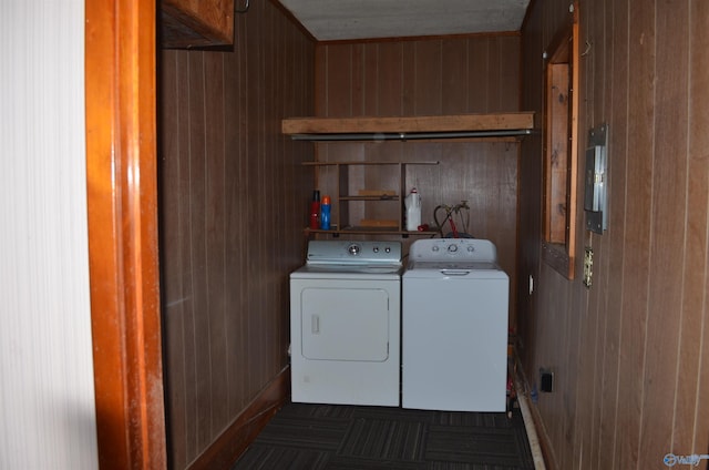 laundry area with independent washer and dryer, laundry area, and wooden walls