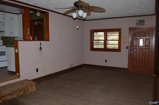 entryway with baseboards, ornamental molding, wood finished floors, and a ceiling fan