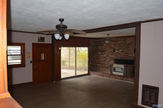 unfurnished living room with heating unit, wood finished floors, and ceiling fan