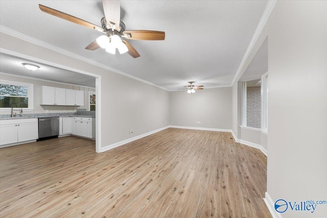 unfurnished living room with ceiling fan, a textured ceiling, crown molding, and light wood-type flooring