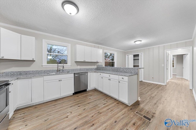 kitchen with appliances with stainless steel finishes, white cabinetry, ornamental molding, and sink