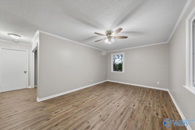 spare room with a textured ceiling, ceiling fan, ornamental molding, and light hardwood / wood-style floors