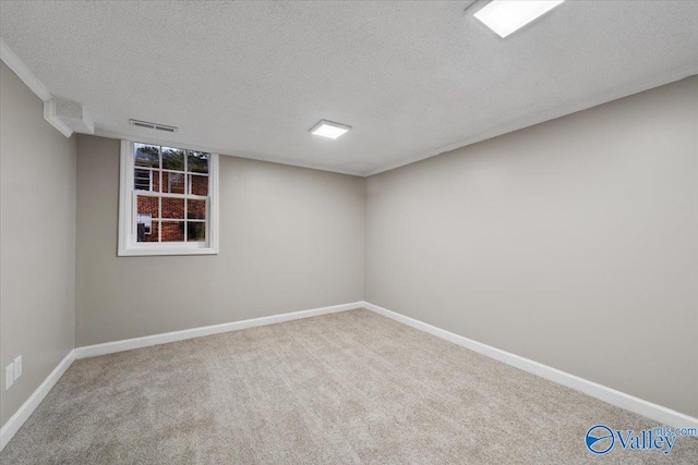 spare room with a textured ceiling and carpet floors