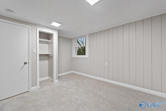 unfurnished bedroom featuring light colored carpet and a textured ceiling