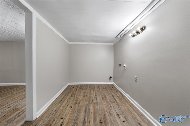 laundry area with washer hookup, light hardwood / wood-style flooring, crown molding, and electric dryer hookup