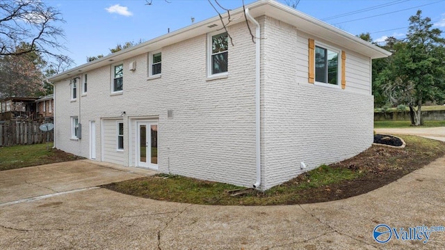 view of side of home featuring a patio area and french doors