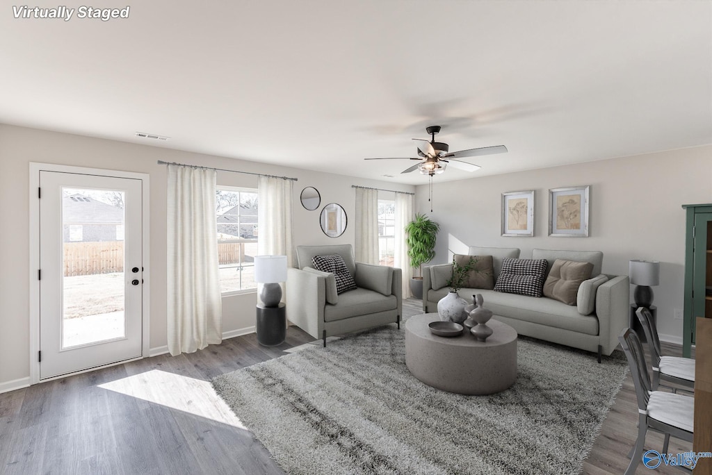 living room with wood-type flooring and ceiling fan