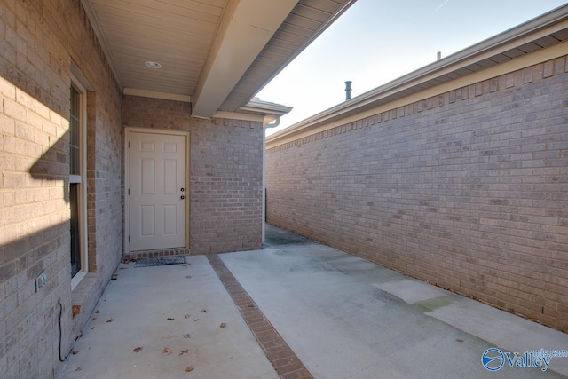 view of exterior entry featuring a patio area