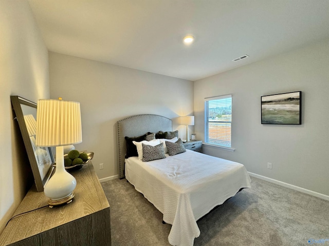 carpeted bedroom featuring visible vents and baseboards