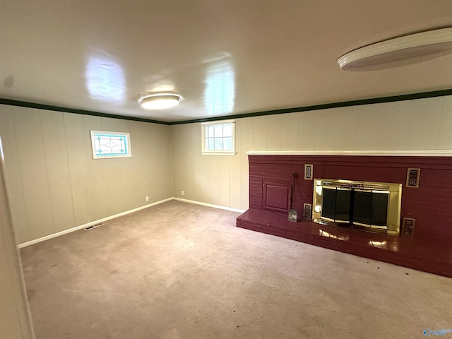 basement with carpet and a brick fireplace