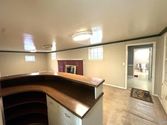 interior space featuring a brick fireplace and white cabinets