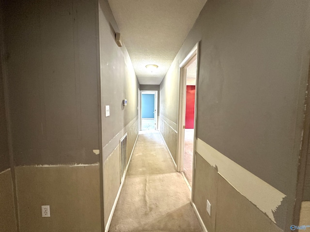 corridor with a textured ceiling