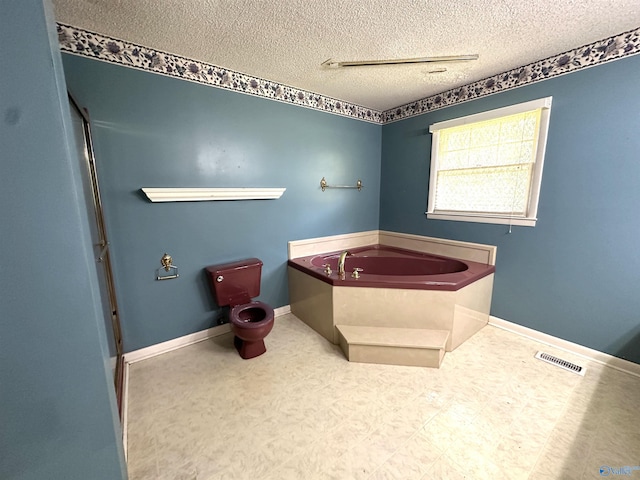 bathroom featuring a bathtub and a textured ceiling