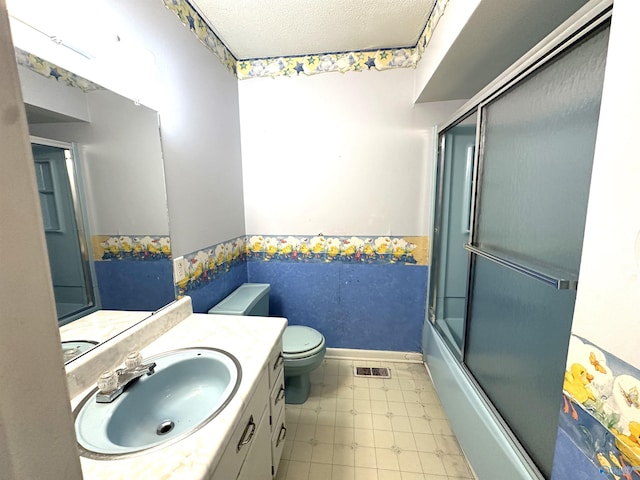 full bathroom featuring vanity, toilet, enclosed tub / shower combo, and a textured ceiling