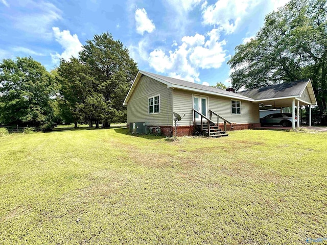 exterior space featuring central AC unit and a yard