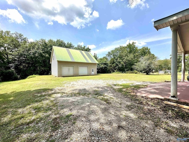 view of yard with a garage and an outdoor structure