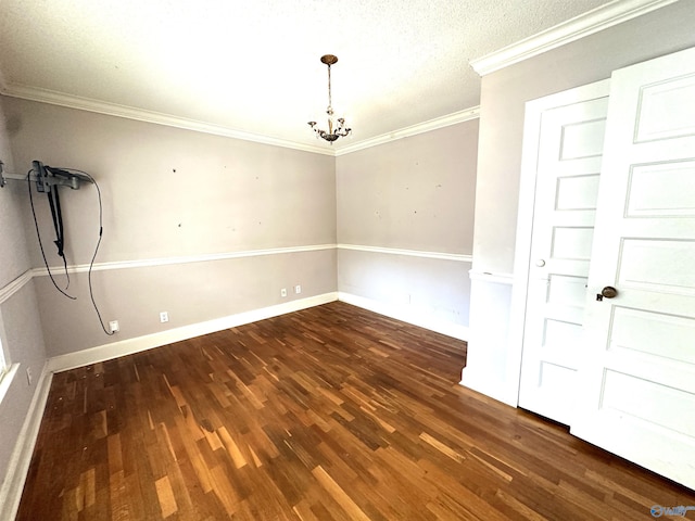 empty room with dark hardwood / wood-style flooring, crown molding, and a chandelier