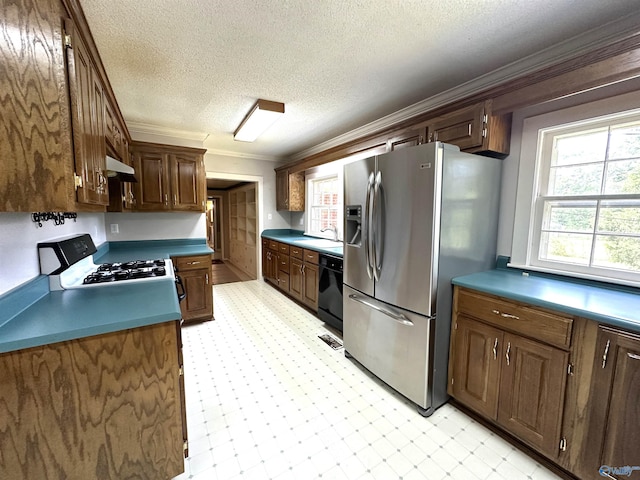 kitchen featuring sink, crown molding, stainless steel fridge, black dishwasher, and range with gas cooktop