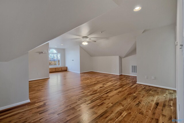 bonus room with ceiling fan, hardwood / wood-style floors, and vaulted ceiling