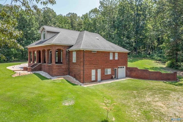 view of side of property featuring a garage and a yard