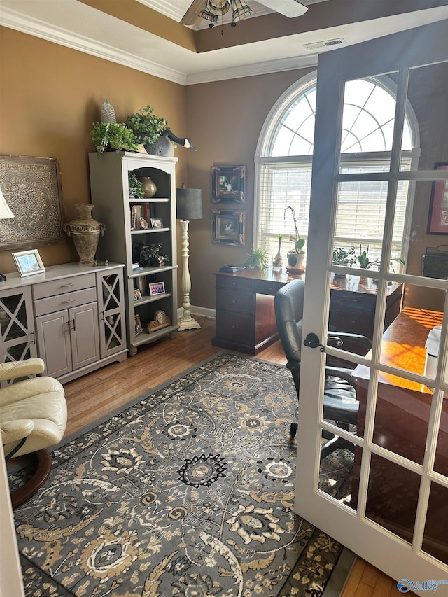 home office featuring hardwood / wood-style flooring, ceiling fan, and ornamental molding