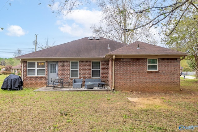 rear view of house with a patio area and a lawn