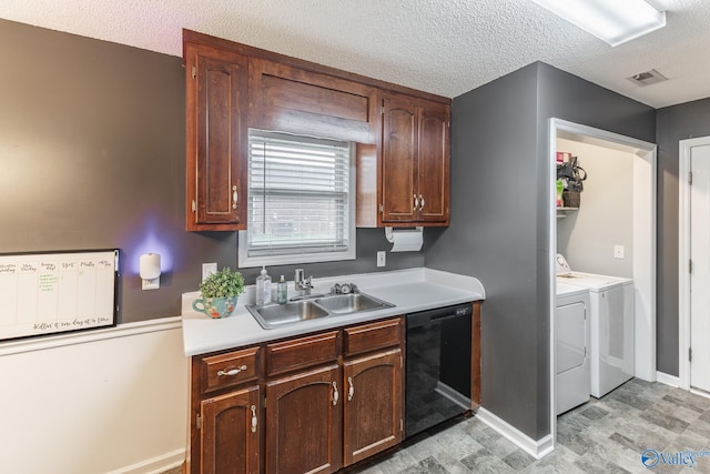 kitchen featuring washing machine and clothes dryer, sink, a textured ceiling, and black dishwasher