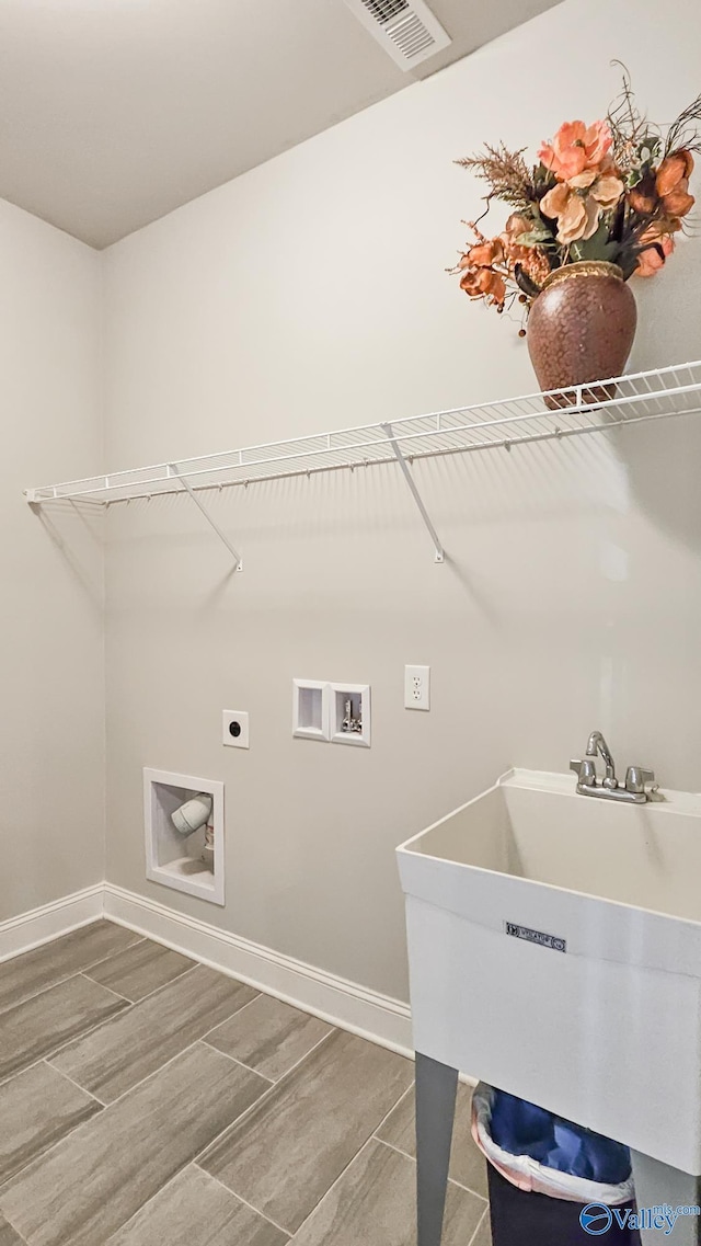 washroom with hookup for an electric dryer, laundry area, washer hookup, a sink, and visible vents