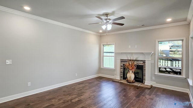 unfurnished living room with dark wood-style floors, crown molding, a fireplace, and baseboards