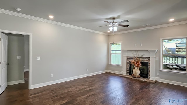 unfurnished living room featuring baseboards, a ceiling fan, ornamental molding, wood finished floors, and a fireplace