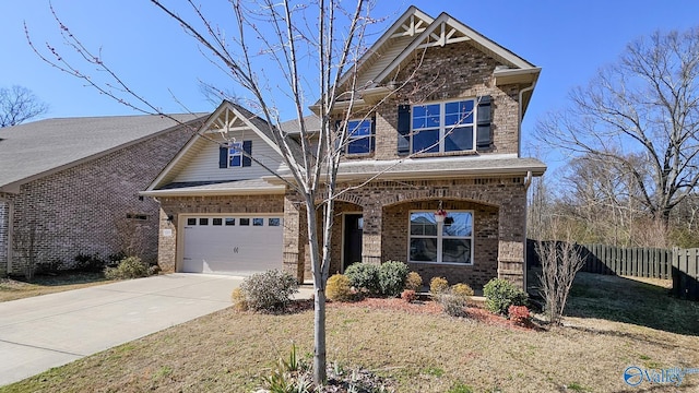 craftsman-style home featuring concrete driveway, brick siding, an attached garage, and fence