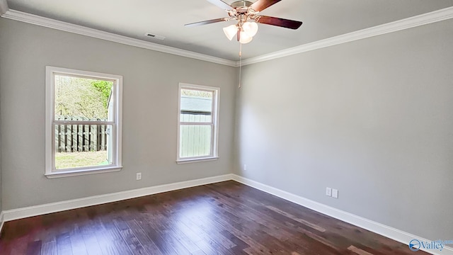 empty room featuring dark wood-style flooring and crown molding