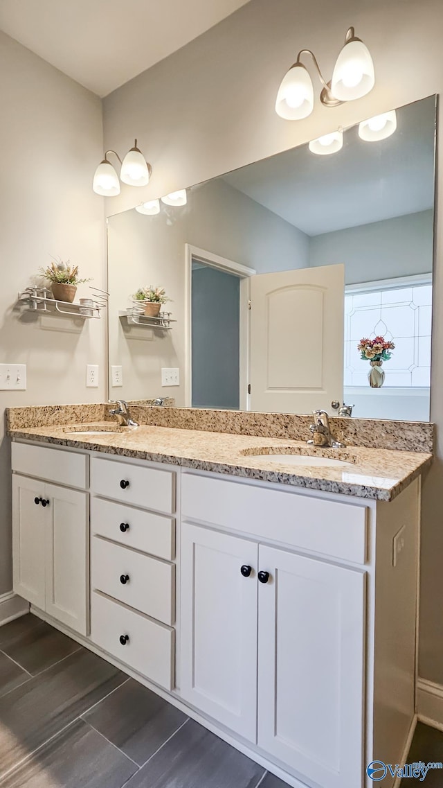 full bathroom with a sink and double vanity