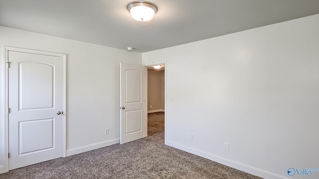 unfurnished bedroom featuring carpet and baseboards