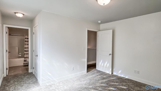 unfurnished bedroom with carpet floors and baseboards