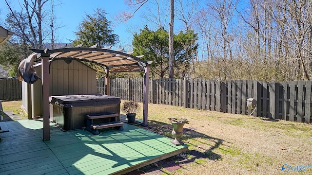 view of yard with a deck, a pergola, a fenced backyard, and a hot tub