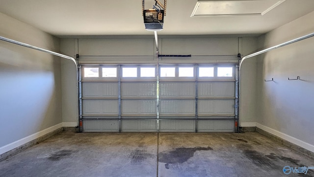 garage with a garage door opener and baseboards