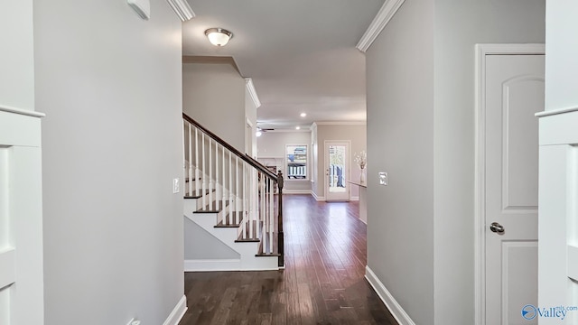 hallway with stairs, ornamental molding, wood finished floors, and baseboards