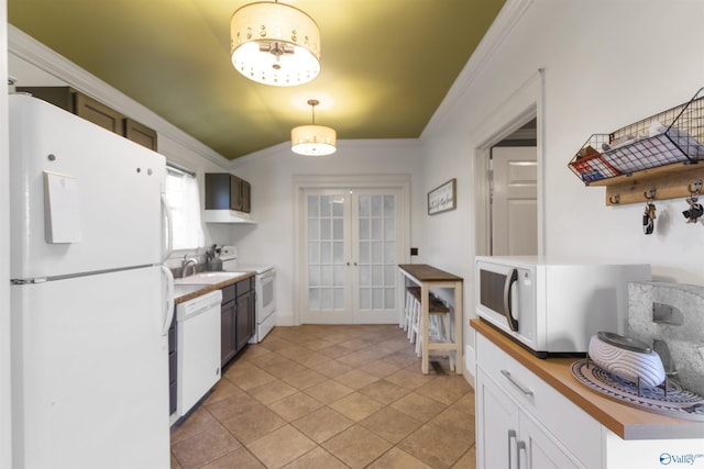 kitchen with french doors, a sink, white appliances, crown molding, and butcher block countertops