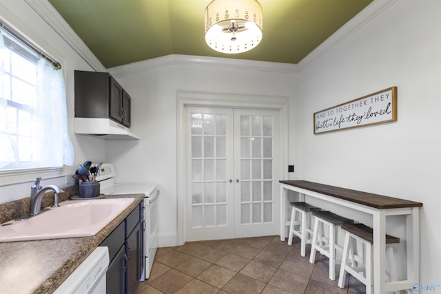 kitchen featuring french doors, under cabinet range hood, white appliances, light tile patterned flooring, and a sink