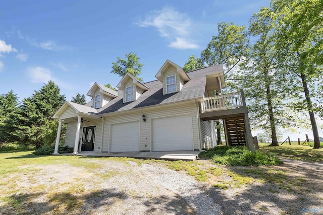 cape cod-style house with ceiling fan, stairs, an attached garage, and driveway