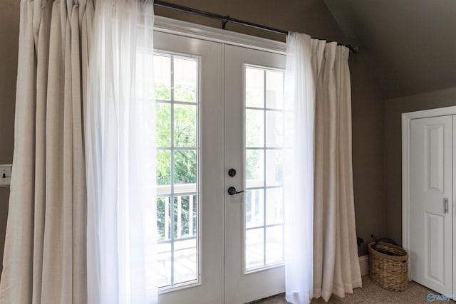entryway featuring french doors and vaulted ceiling