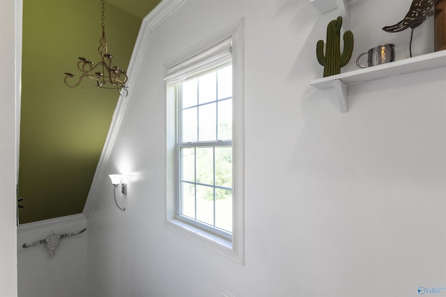 interior details with an inviting chandelier and ornamental molding