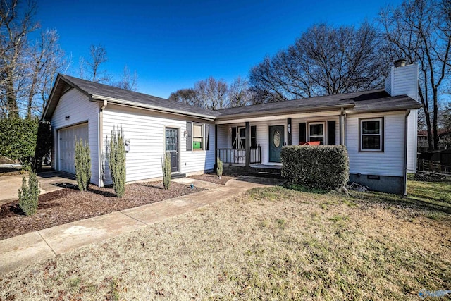 ranch-style house featuring a garage, a front yard, and covered porch