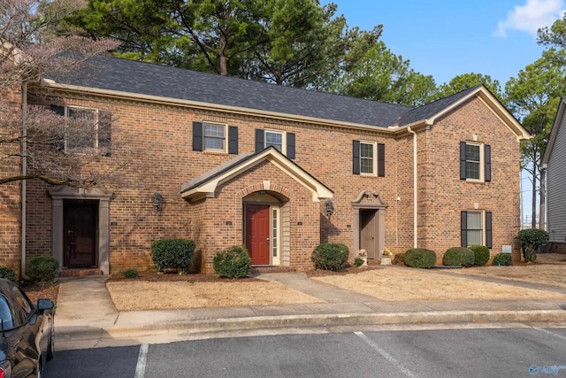 view of front of property with brick siding and uncovered parking