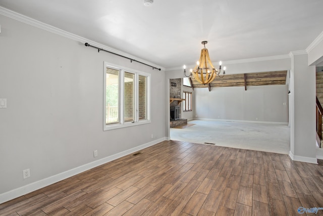 unfurnished living room with hardwood / wood-style flooring, ornamental molding, and a large fireplace