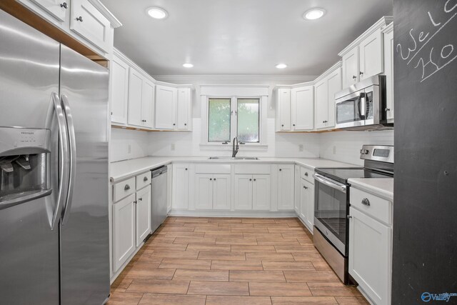 kitchen with sink, stainless steel appliances, and white cabinets