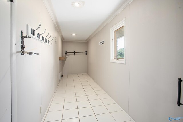 interior space with light tile patterned floors and ornamental molding